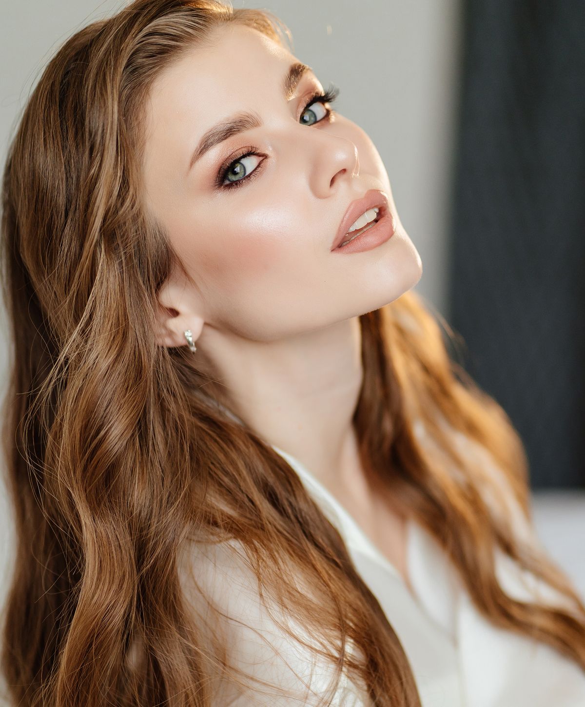 Woman with long hair and elegant makeup.