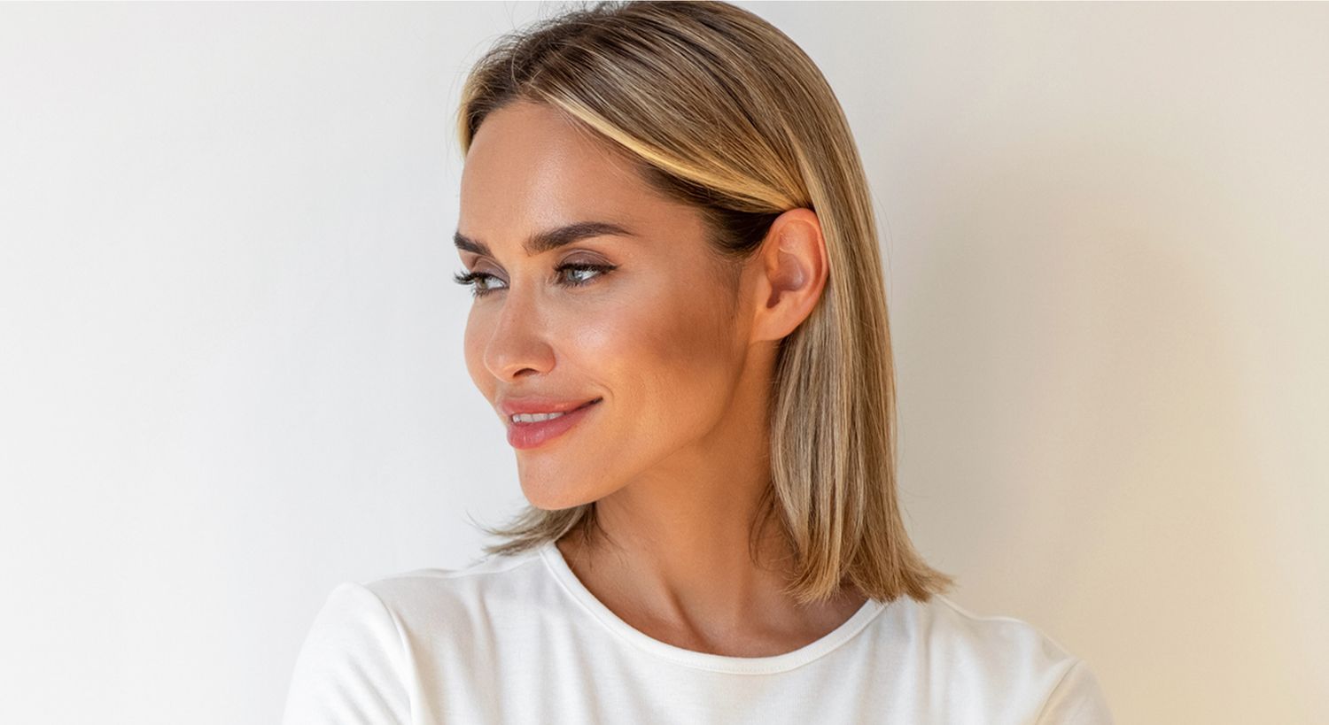 Woman with a radiant smile and blonde hair.