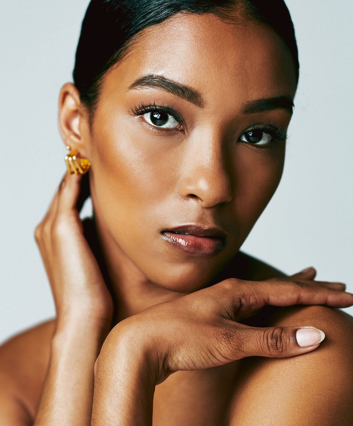 Close-up of a woman's face and hands.