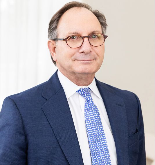 Businessman in suit with glasses and blue tie.
