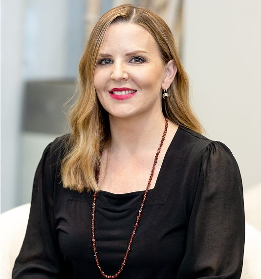 Professional portrait of a smiling woman.