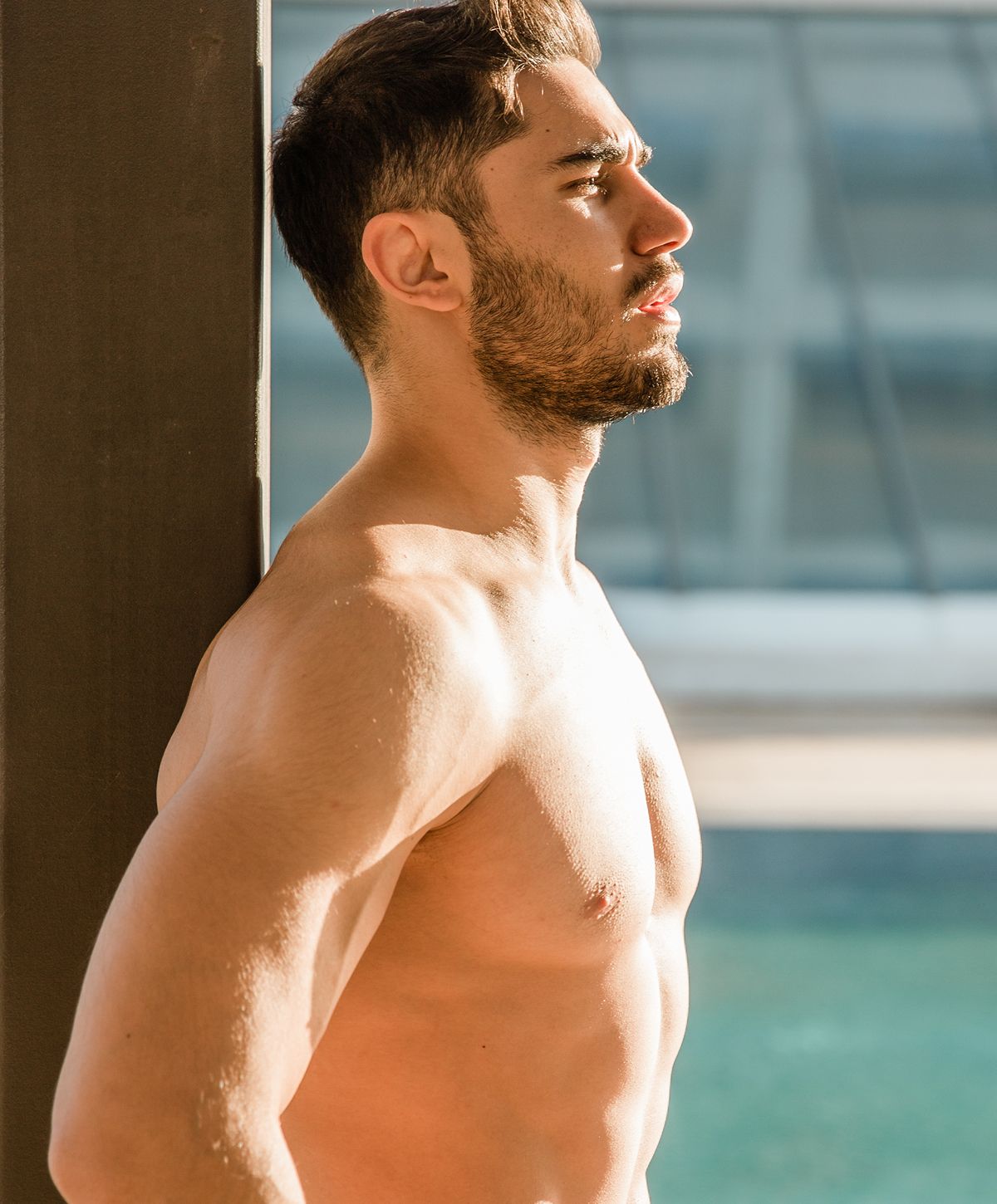 Model in gray jeans sitting on the floor.