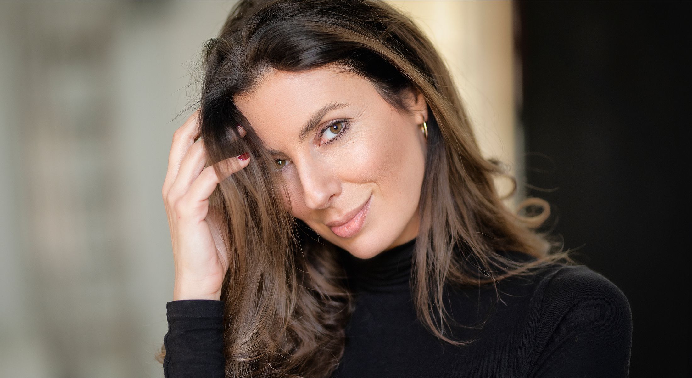 Woman stretching in gray athletic wear.