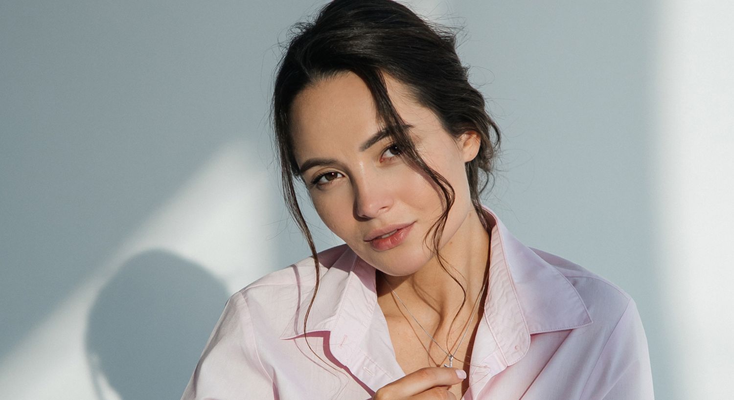 Woman in pink shirt with soft lighting.