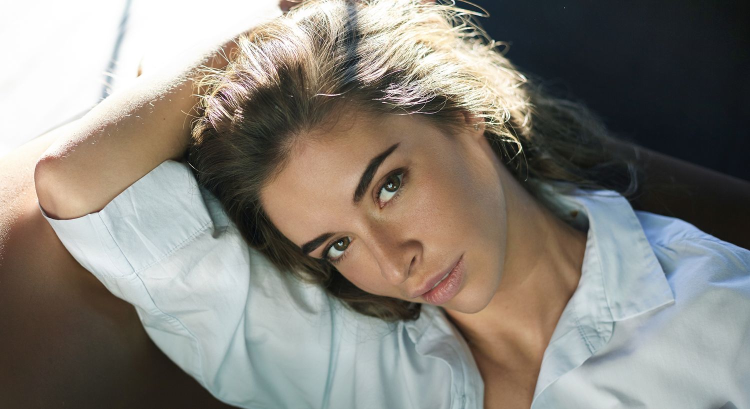 Woman with light hair in white shirt.